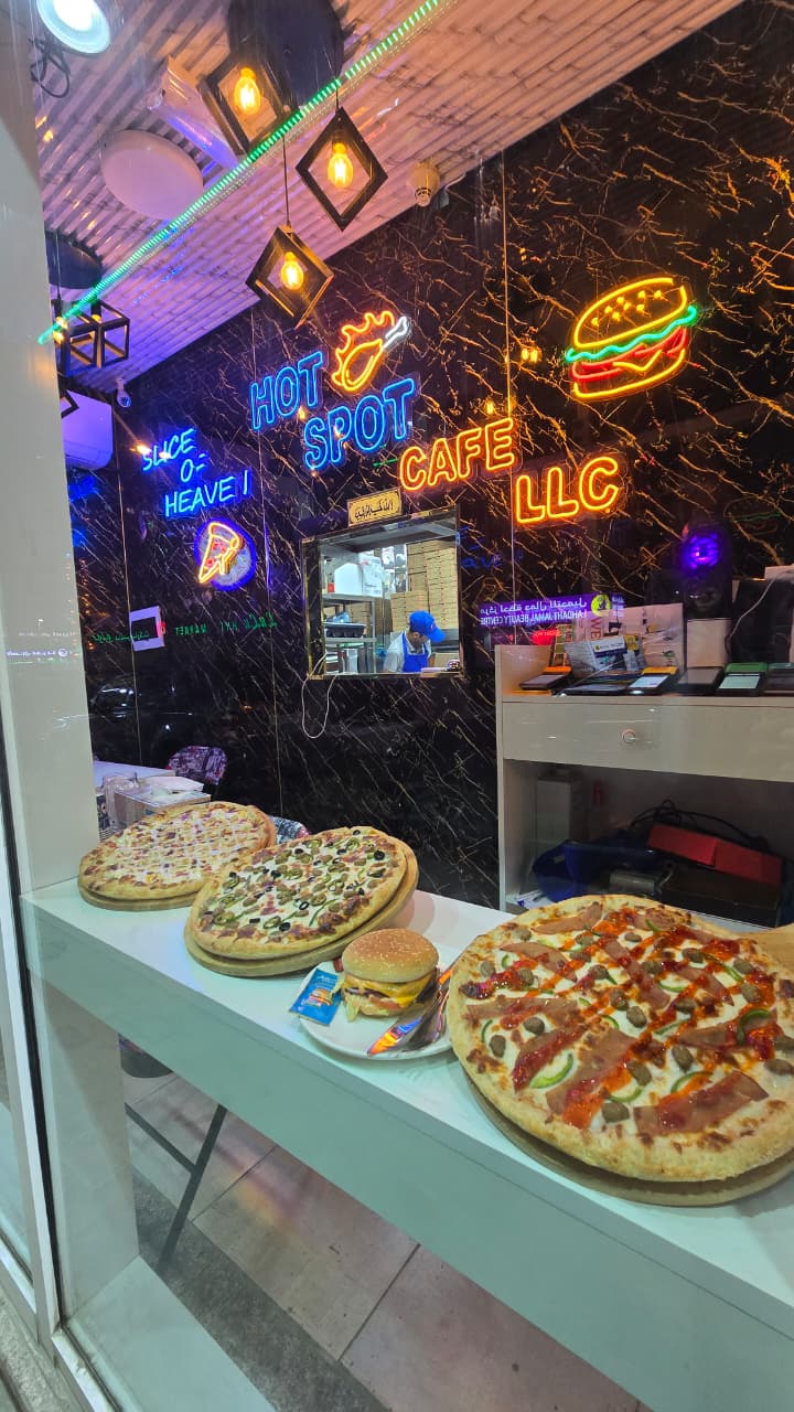 Hot Spot Cafe interior with fresh pizzas and neon signs
