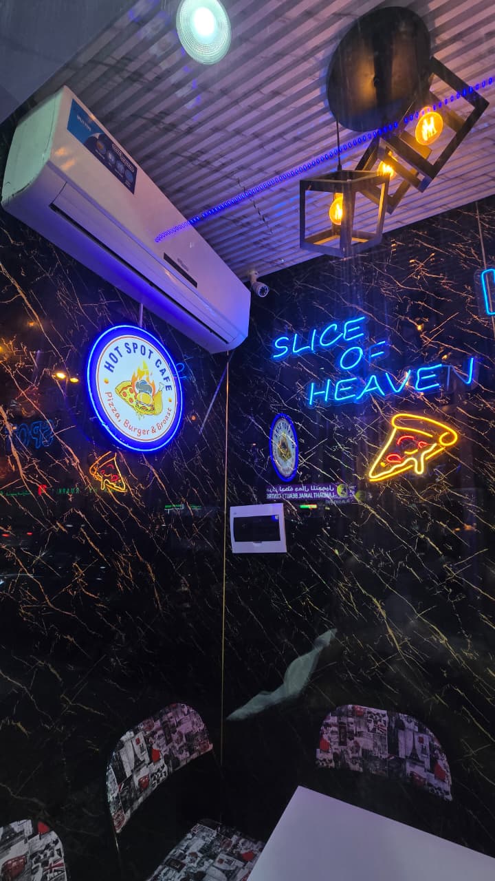 Slice of Heaven neon sign with Hot Spot Cafe branding